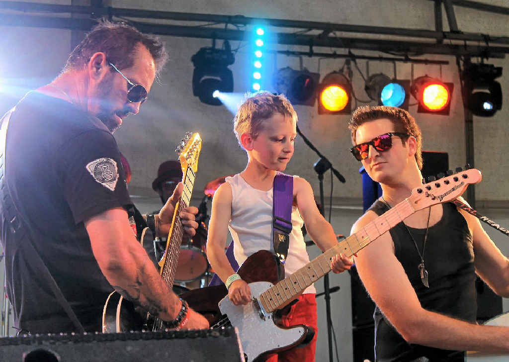 YOUNG STAR: Six-year-old Zeke McGurk enjoyed his first Muster, winning an electric guitar and performing on stage with Forever Road’s Jake Gilroy (left) and Jay Seeney at the Mountview Music Muster.